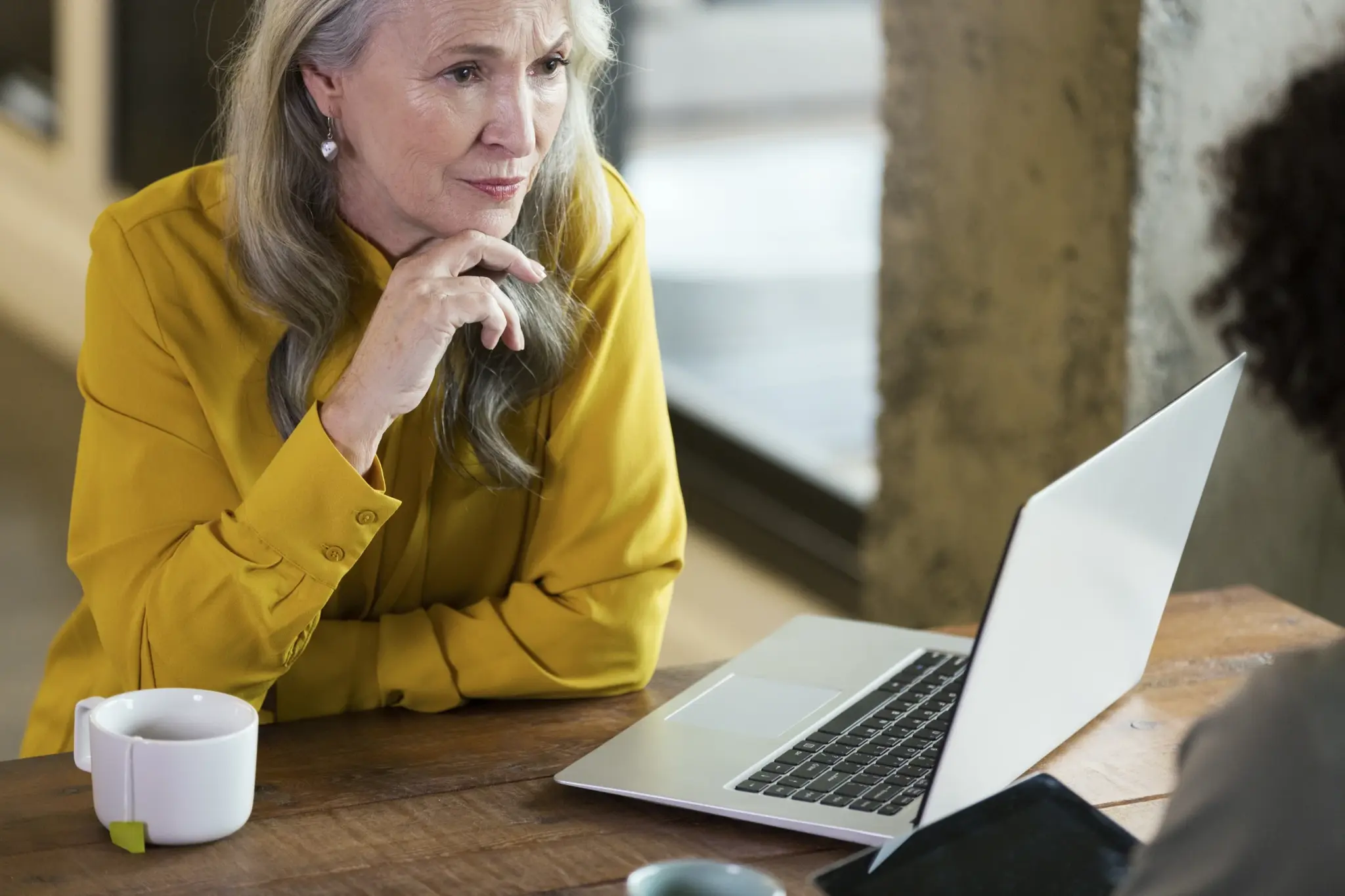 Woman talking at desk with computer